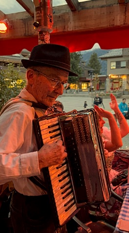Gary Wenzlaff playing under red stage light at an evening event.